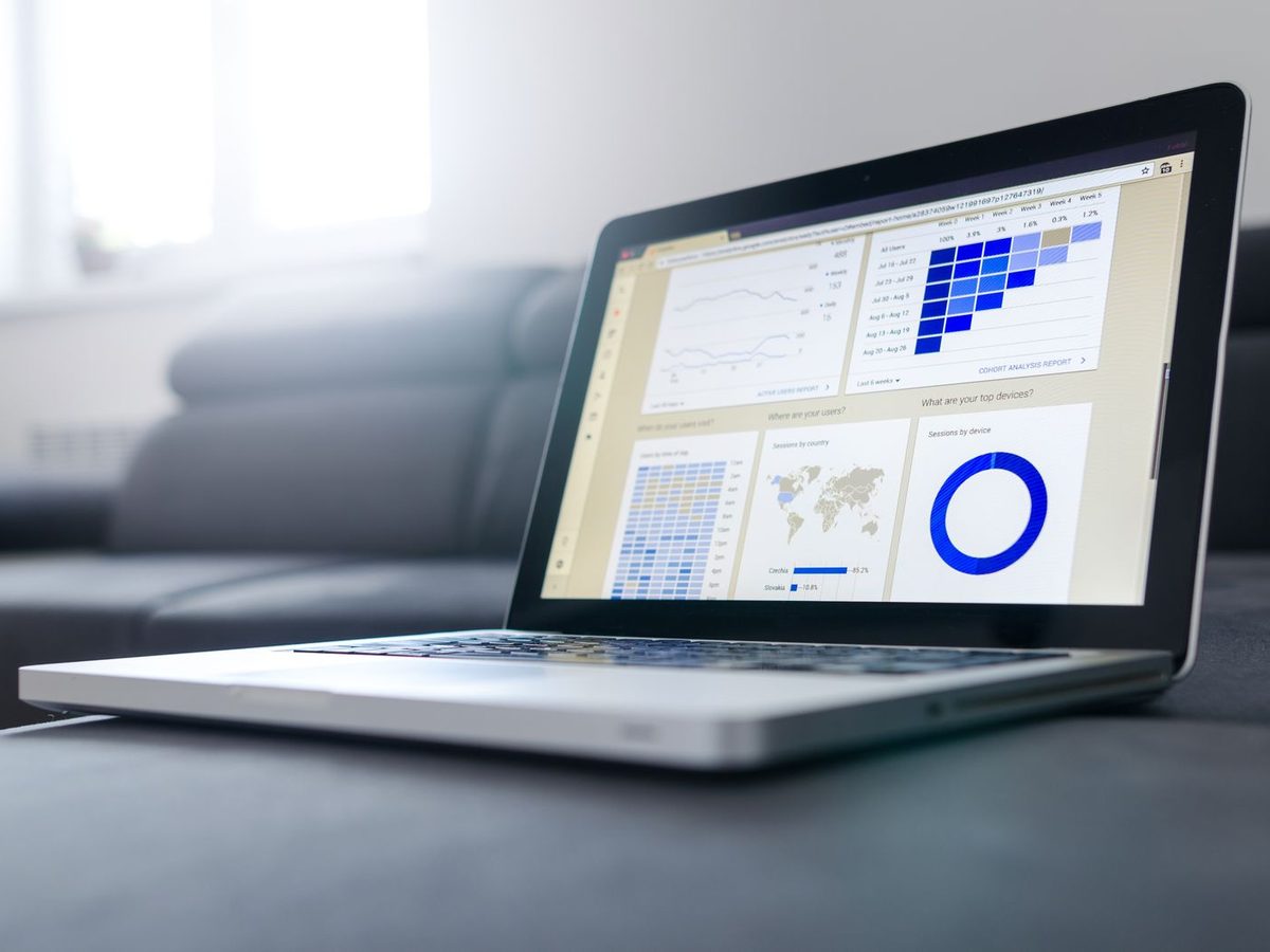 Illustrative photo: a laptop displaying an analytics dashboard with charts and graphs